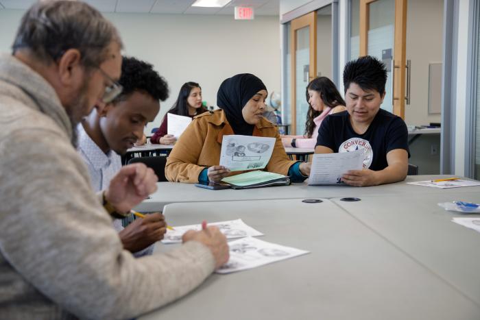 Adult students work in a classroom