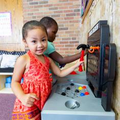 Children playing with toy tools