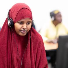 Woman with headphones working at computer