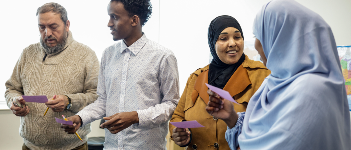 Adult learners practicing speaking English.