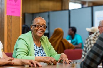 Smiling Ethiopian woman sitting at a table