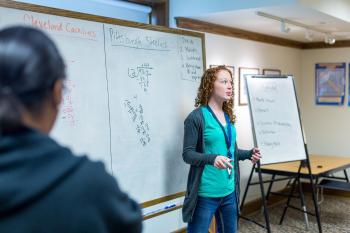 teacher standing in front of a whiteboard