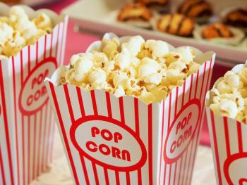 red and white striped container of popped popcorn