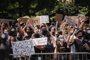 protesters holding up signs following the murder of George Floyd