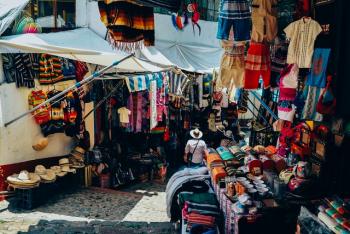 Outdoor market stall hung with colorful clothing