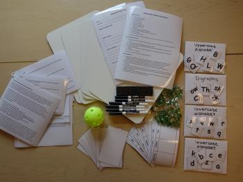 a prepared phonics kit with letter cards, instruction sheets and dry erase boards