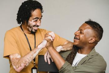 an adult educator gives a high five to an adult student