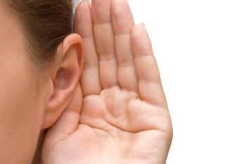 a hand being held up to an ear to listen
