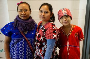 Three Karen people wearing traditional clothing